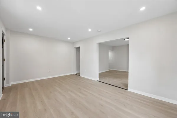 wooden floor in an empty room with a bathroom