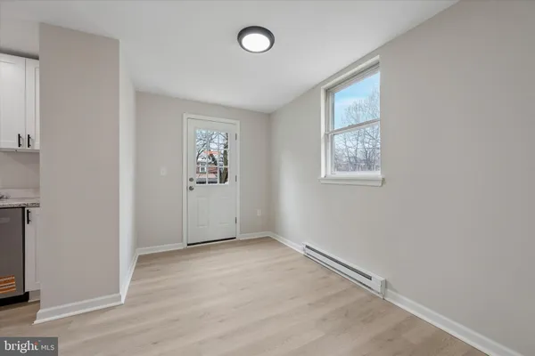 an empty room with windows and closet