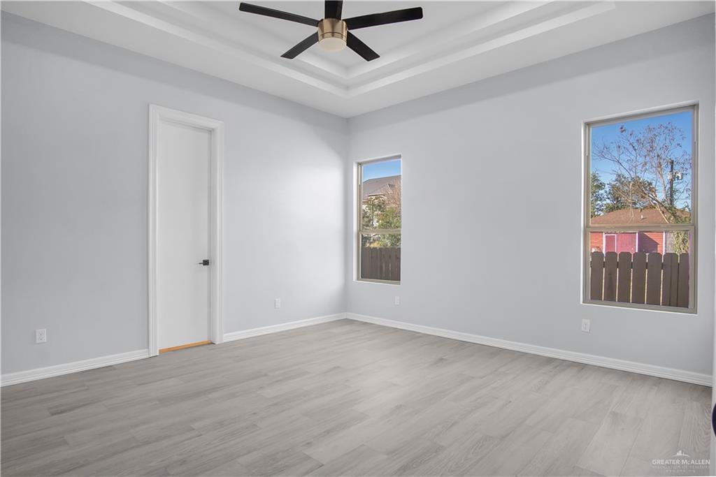 607 North 9th Street Alamo, TX 78516 - Photo 11 of 24 wooden floor in an empty room with a window
