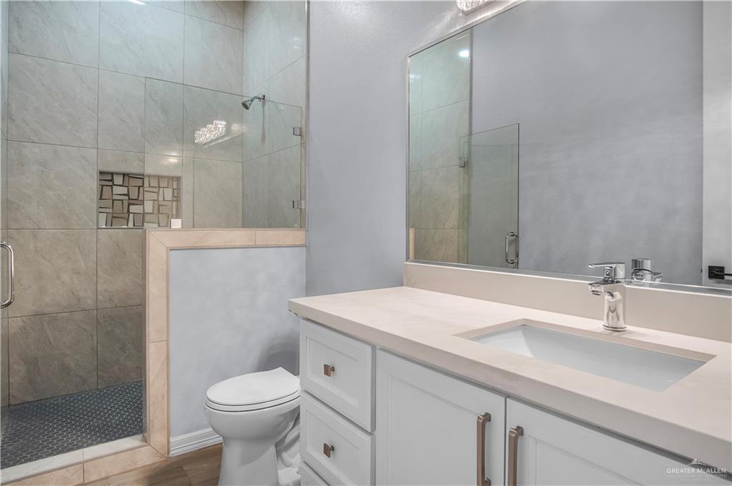 607 North 9th Street Alamo, TX 78516 - Photo 12 of 24 a bathroom with a sink toilet and shower