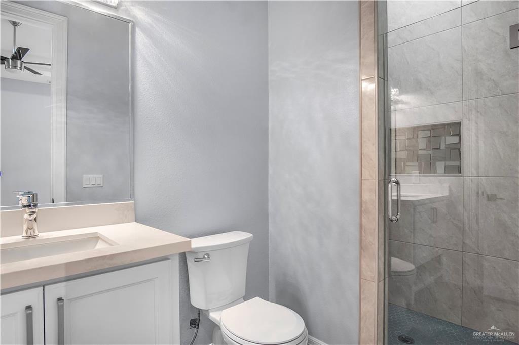 607 North 9th Street Alamo, TX 78516 - Photo 14 of 24 a bathroom with a sink toilet and shower