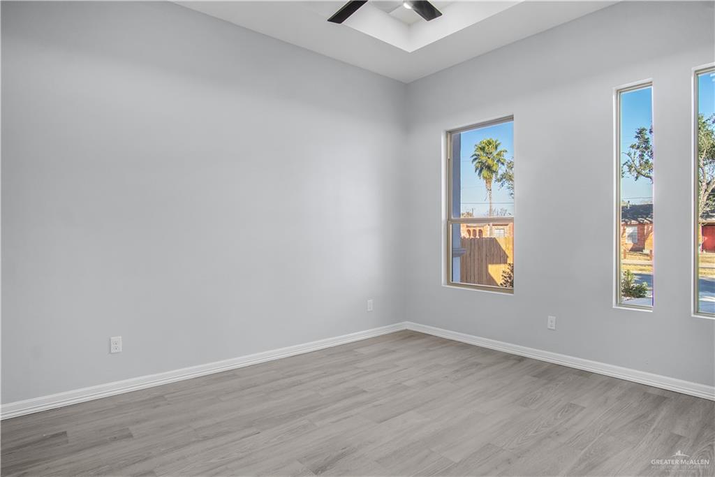 607 North 9th Street Alamo, TX 78516 - Photo 10 of 24 wooden floor in an empty room with a window