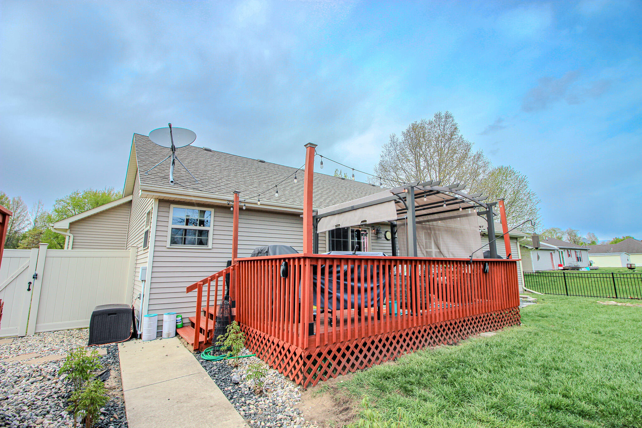 2913 Cardinal Drive Wheatfield, IN 46392 - Photo 29 of 34 a view of a house with wooden deck and garden
