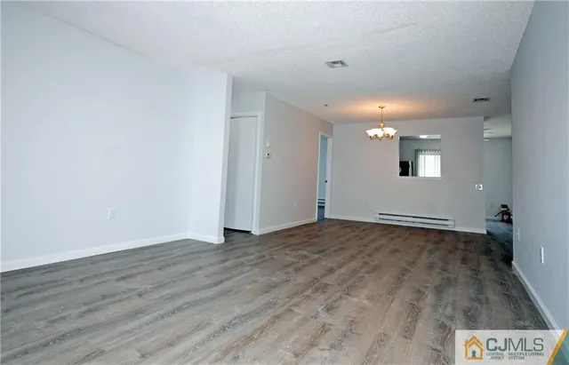 a view of an empty room and wooden floor