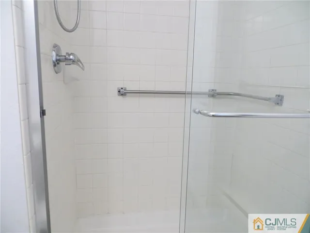 a bathroom with a glass shower door