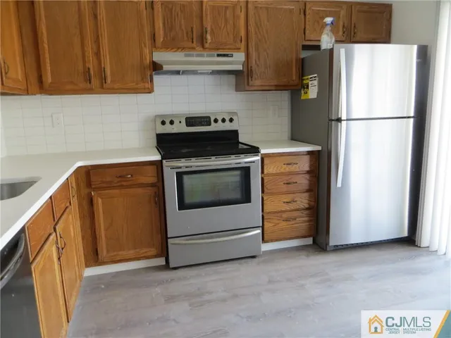a kitchen with cabinets and white appliances