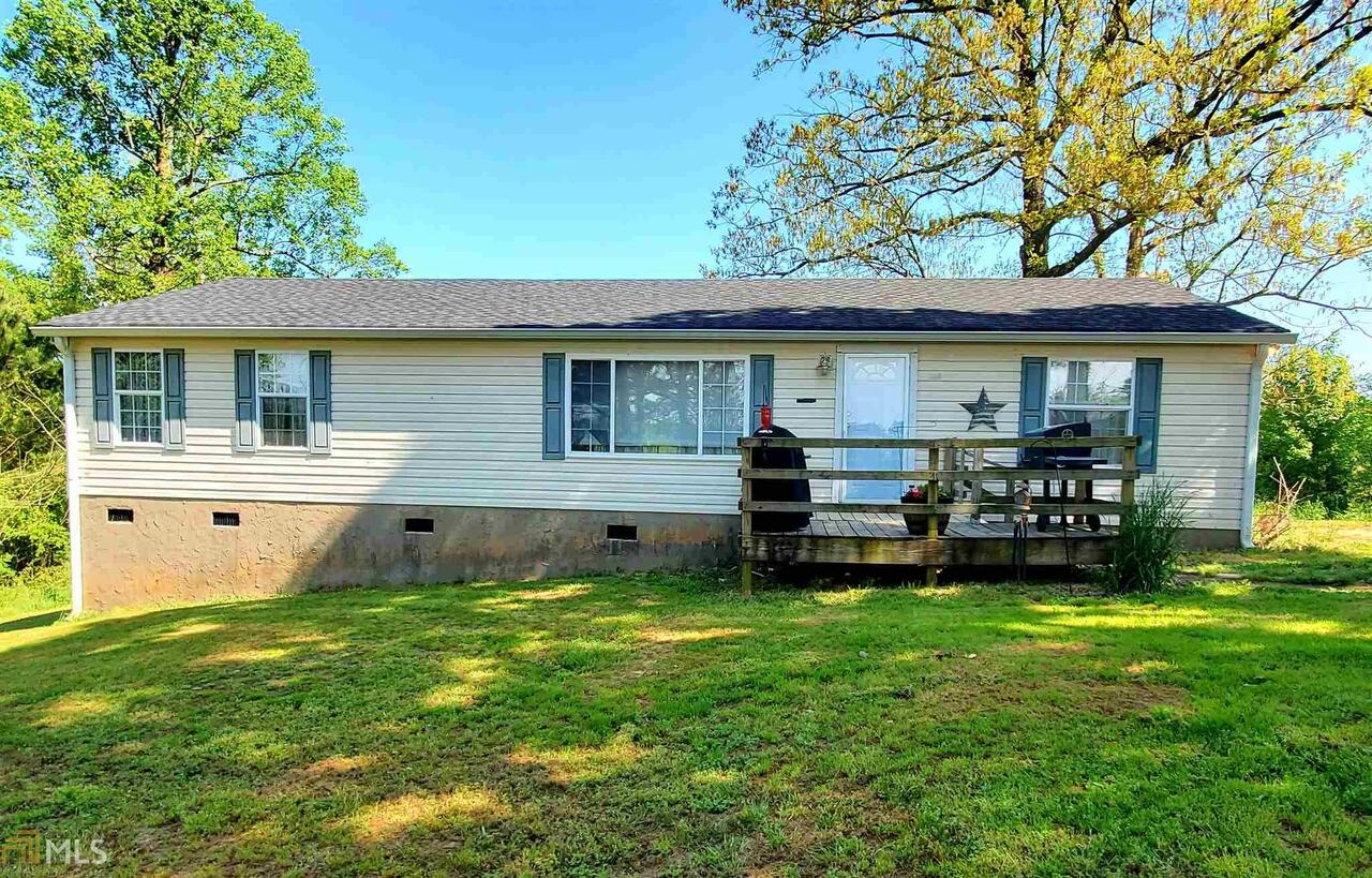 a view of a house with a backyard