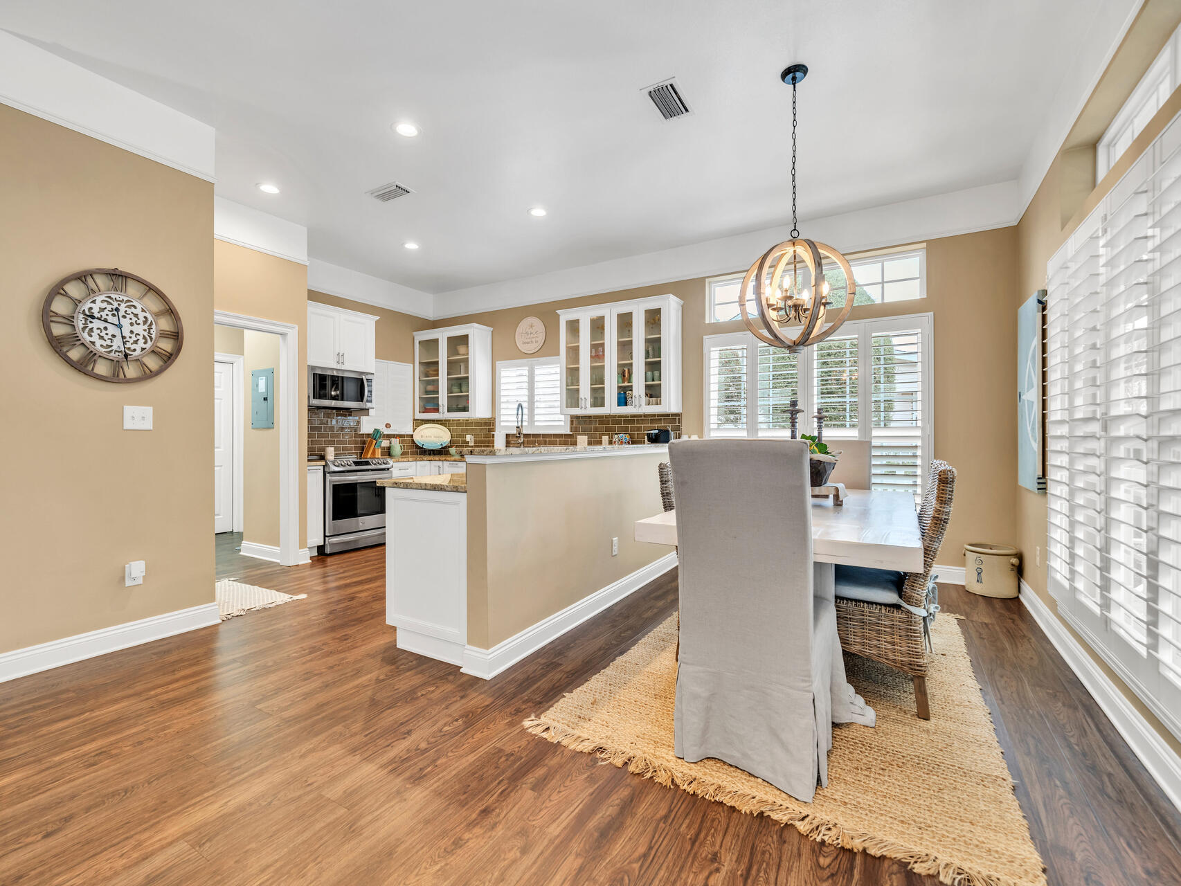 4497 Clipper Cove Destin, FL 32541 - Photo 14 of 44 a view of a dining room and livingroom with furniture wooden floor a chandelier