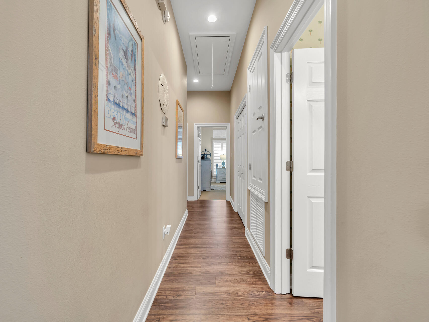 4497 Clipper Cove Destin, FL 32541 - Photo 17 of 44 a view of a hallway with wooden floor and staircase