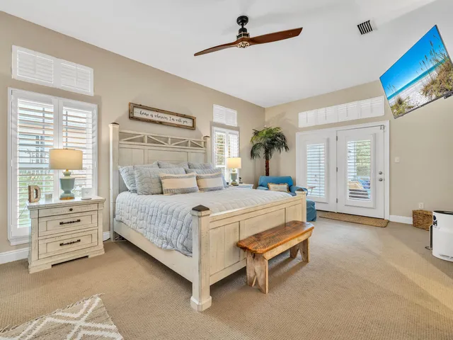 a spacious bedroom with a bed and a cabinets