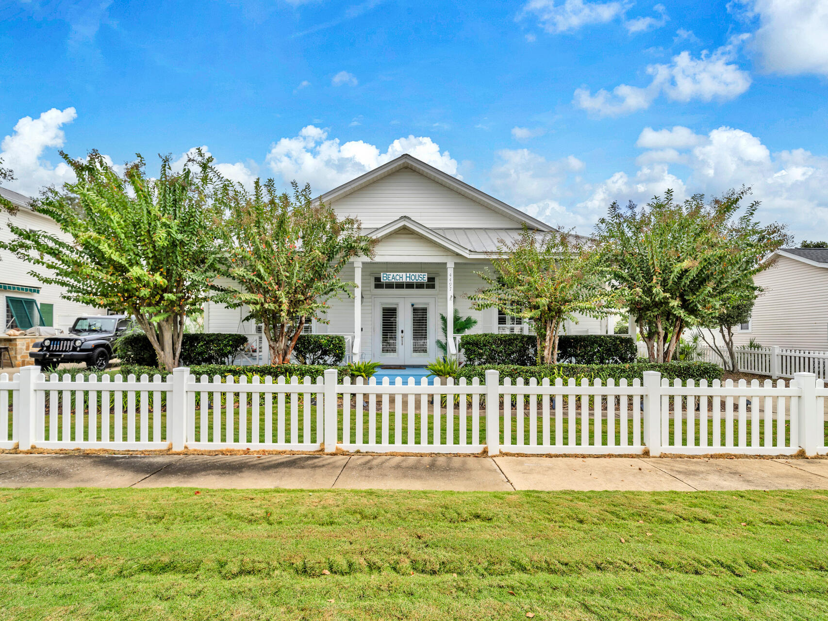 4497 Clipper Cove Destin, FL 32541 - Photo 2 of 44 a front view of a house with a garden and plants