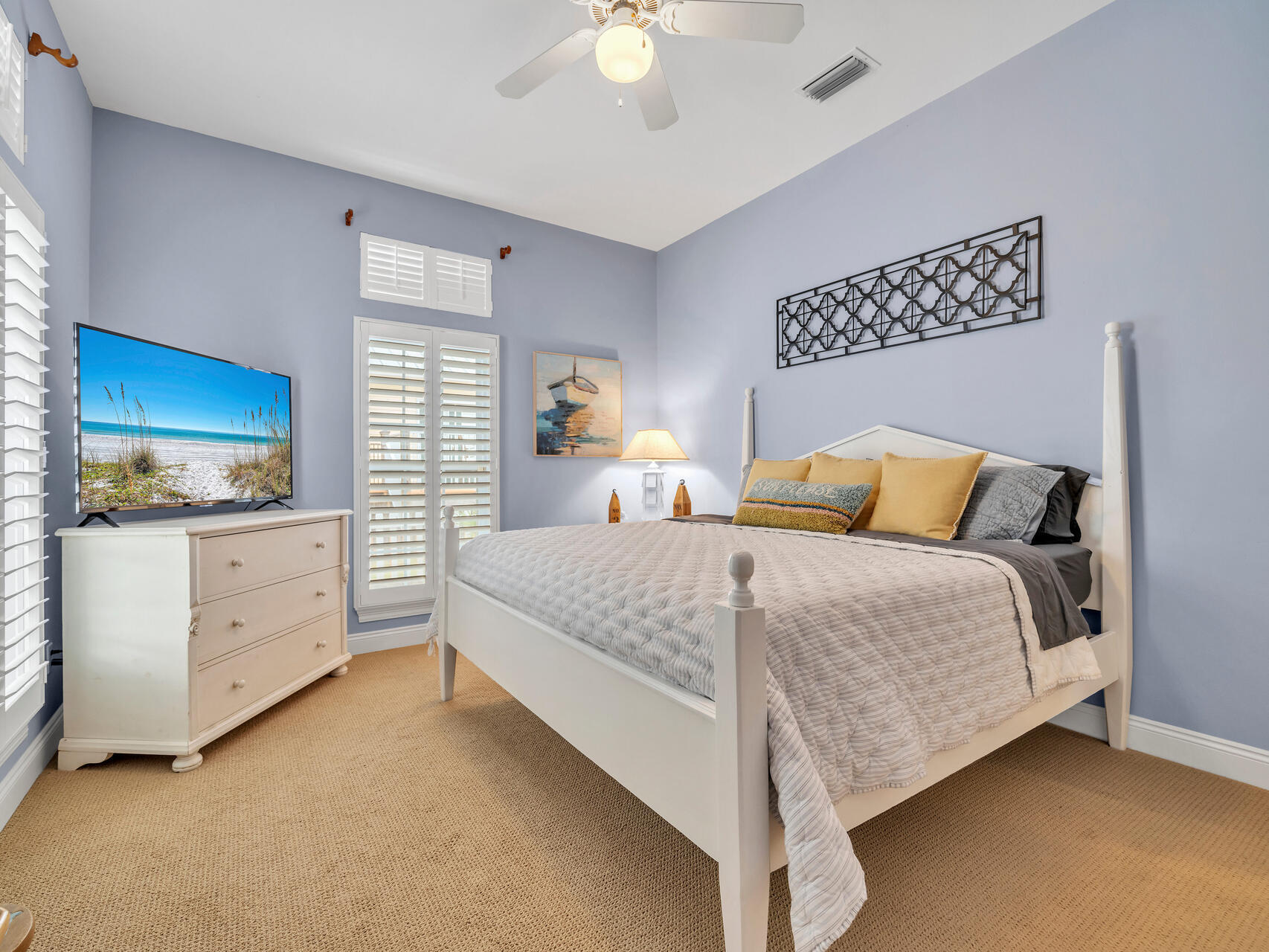 4497 Clipper Cove Destin, FL 32541 - Photo 26 of 44 a bedroom with a bed and a dresser