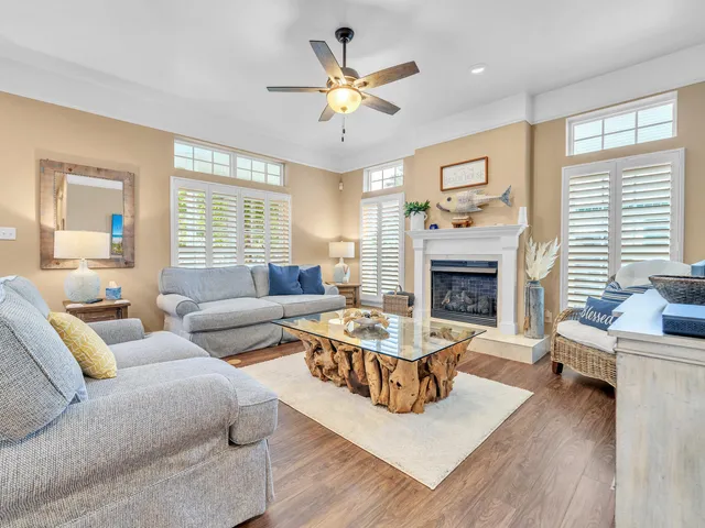 a living room with furniture fireplace and a large window