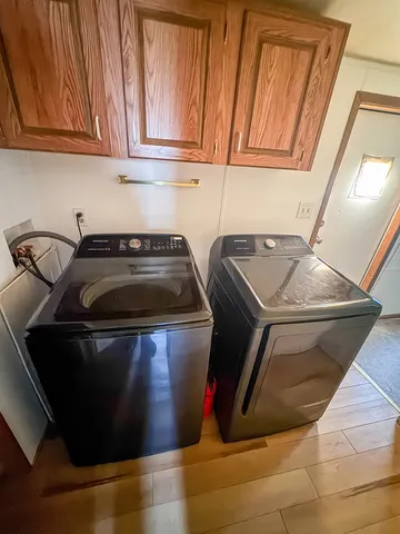 a kitchen with washing machine and cabinets