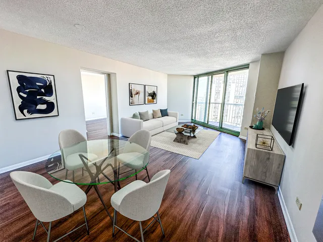 a living room with furniture fireplace and flat screen tv