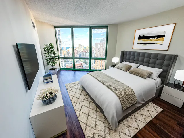 a bedroom with furniture and a flat screen tv