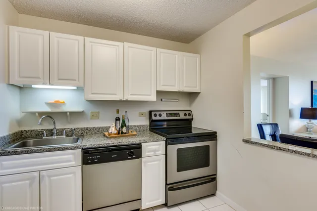 a kitchen with white cabinets and white appliances