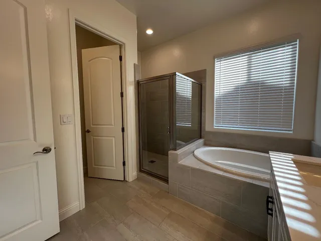 a spacious bathroom with a bathtub and a shower