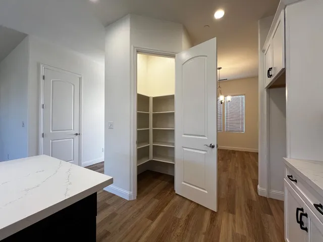 a room with wooden floor and closet