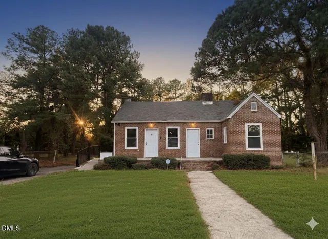 a front view of a house with a garden