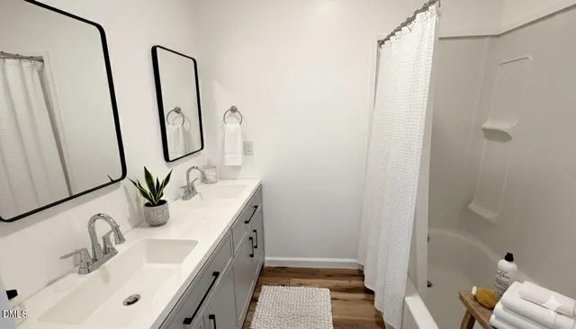a bathroom with double vanity sink a toilet and a mirror