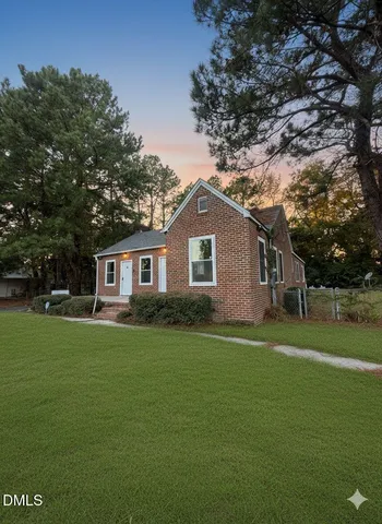 a front view of a house with a garden