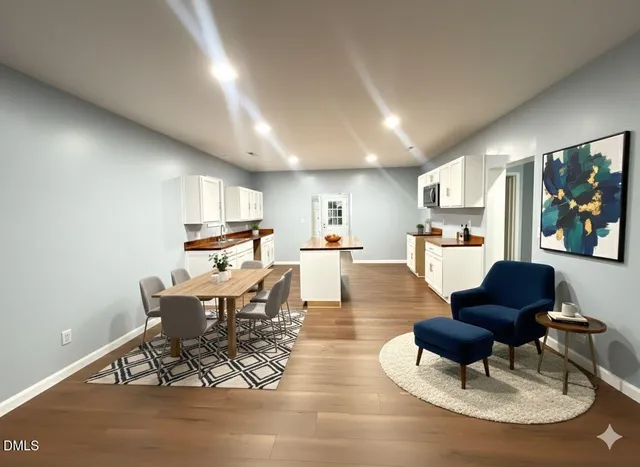 a living room with fireplace furniture and a wooden floor