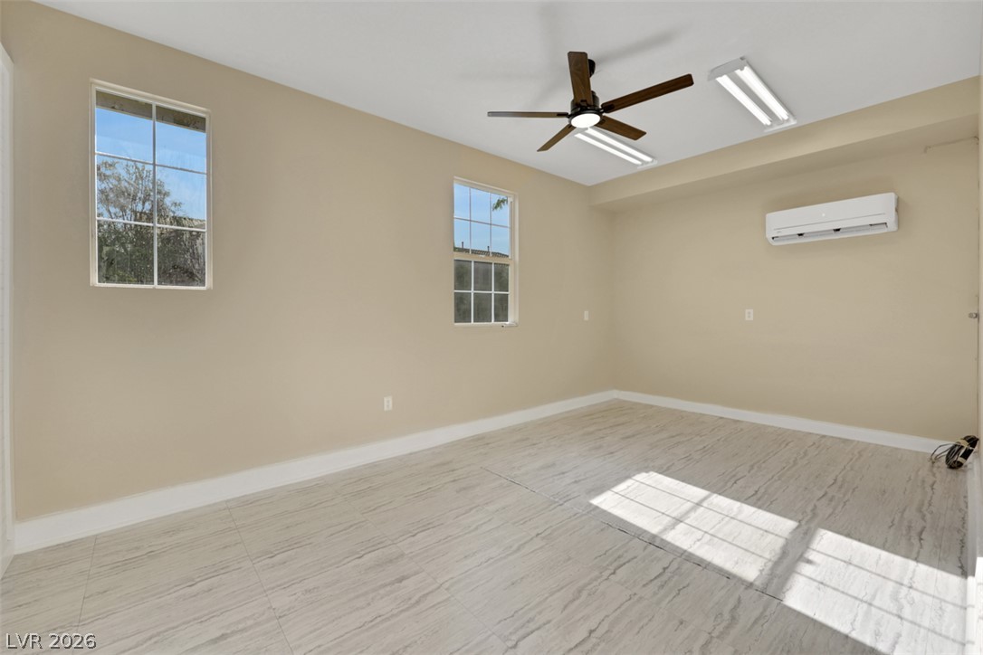10328 Hawk Ravine Street Las Vegas, NV 89178 - Photo 50 of 55 A versatile interior space featuring neutral tones, practical flooring, and ample natural light.