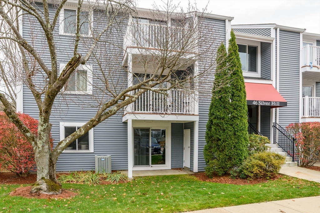 46 Silver Hill Lane, Unit 1 Natick, MA 01760 - Photo 1 of 11 a front view of a house with a garden