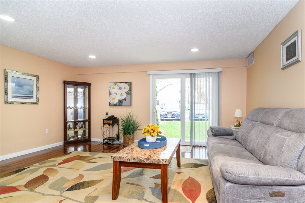 46 Silver Hill Lane, Unit 1 Natick, MA 01760 - Photo 2 of 11 a living room with furniture and a table