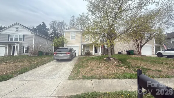 a car parked in front of a white house