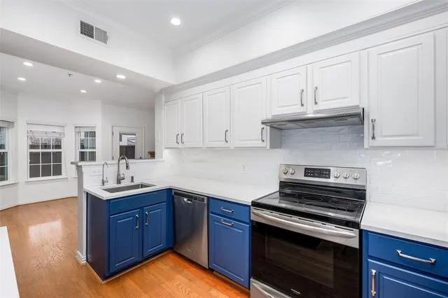 a kitchen with granite countertop a sink and cabinets