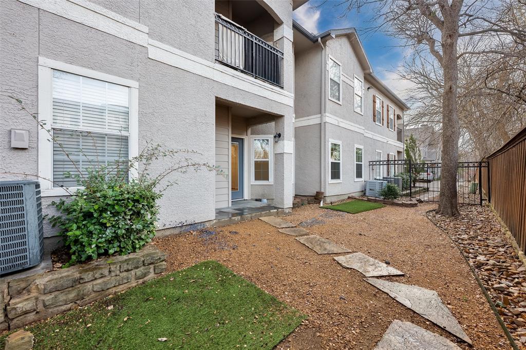 2601 Preston Road, Unit 6108 Plano, TX 75093 - Photo 24 of 26 a view of a brick house with a yard plants and large tree