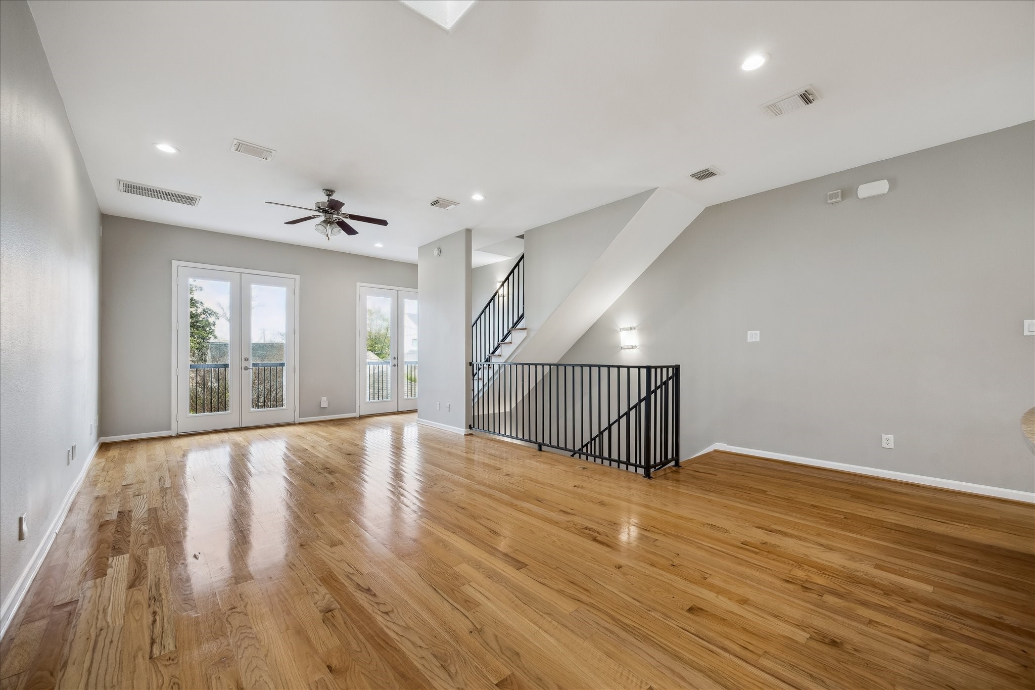 802 Waverly Street, Unit D Houston, TX 77007 - Photo 3 of 30 a view of an empty room with wooden floor and a window