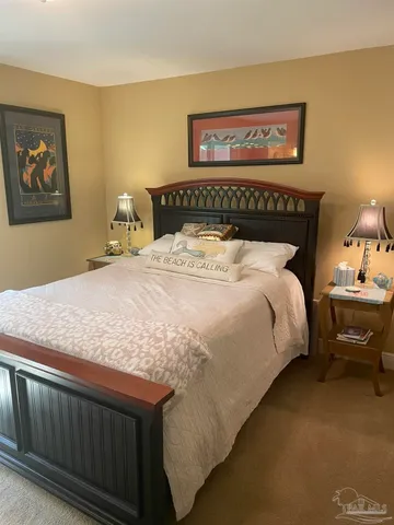 a large bed sitting in a bedroom next to a wall