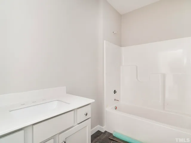 a bathroom with a bathtub and shower