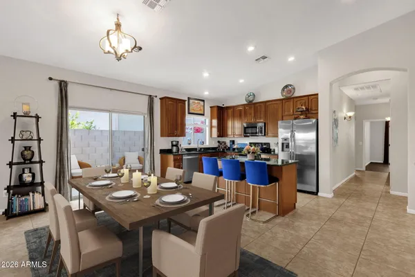 a spacious bedroom with a bed and a flat screen tv