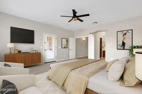 a bedroom with a bed and a large window