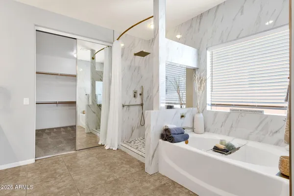 a bedroom with bed and a flat screen tv