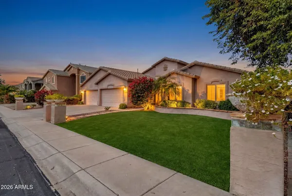 a front view of a house with a garden