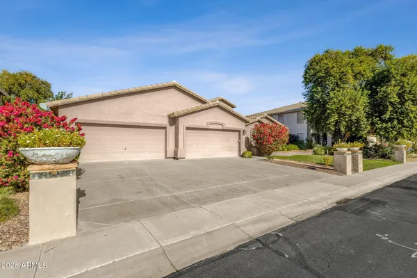 a front view of a house with flower plants
