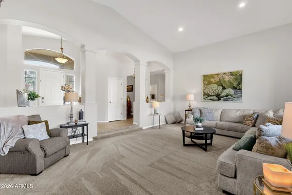 a kitchen with stainless steel appliances granite countertop a stove top oven a sink a dining table and chairs with wooden floor