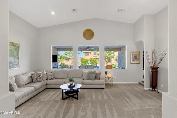 a kitchen with stainless steel appliances granite countertop a refrigerator a stove top oven a sink dishwasher and white cabinets with wooden floor