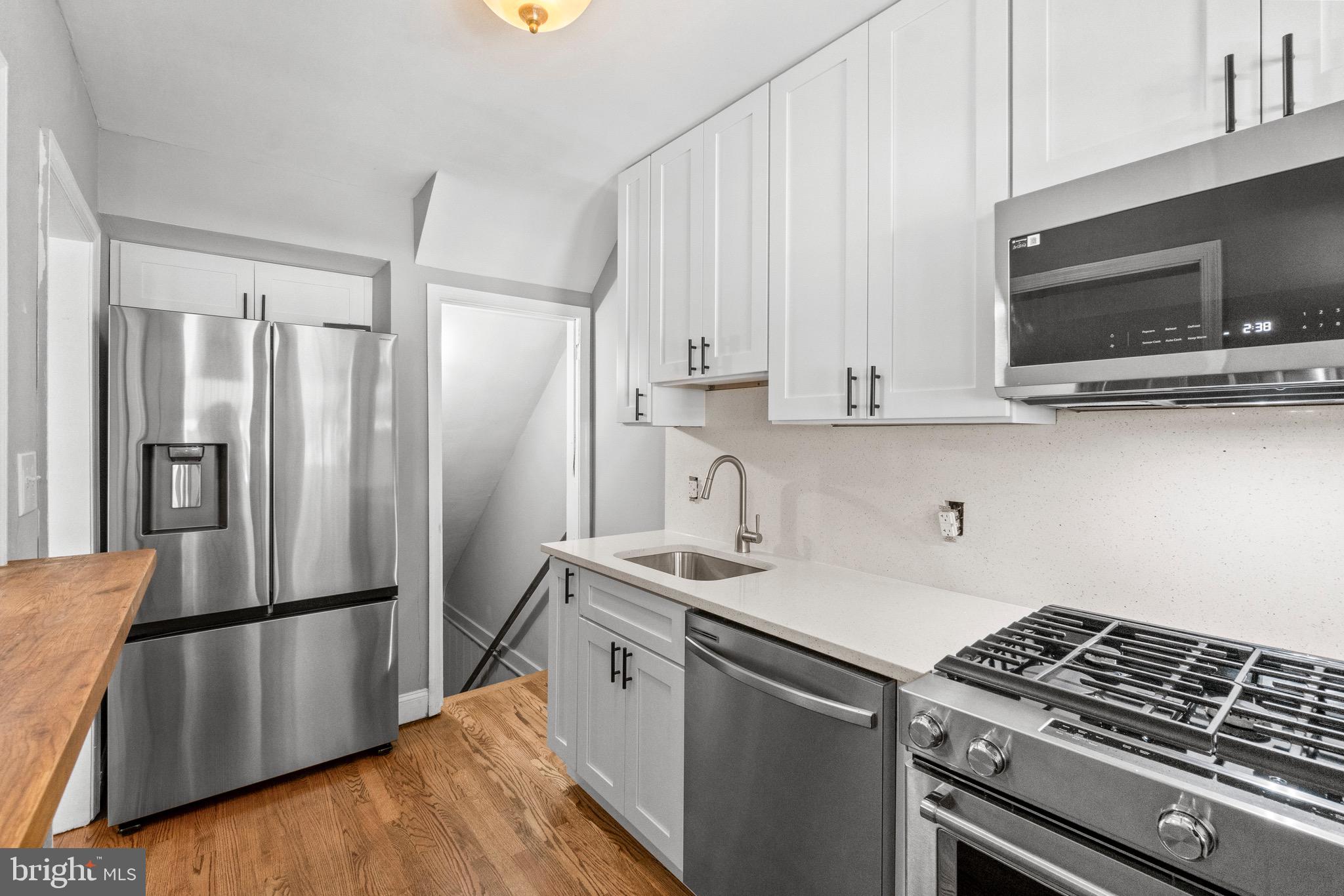 2214 Hawthorne Road Baltimore, MD 21220 - Photo 12 of 28 a kitchen with stainless steel appliances a refrigerator stove and microwave