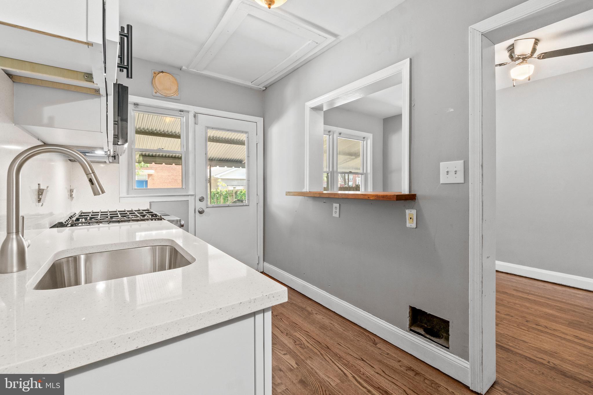 2214 Hawthorne Road Baltimore, MD 21220 - Photo 14 of 28 a view closeup a sink and dishwasher with wooden floor