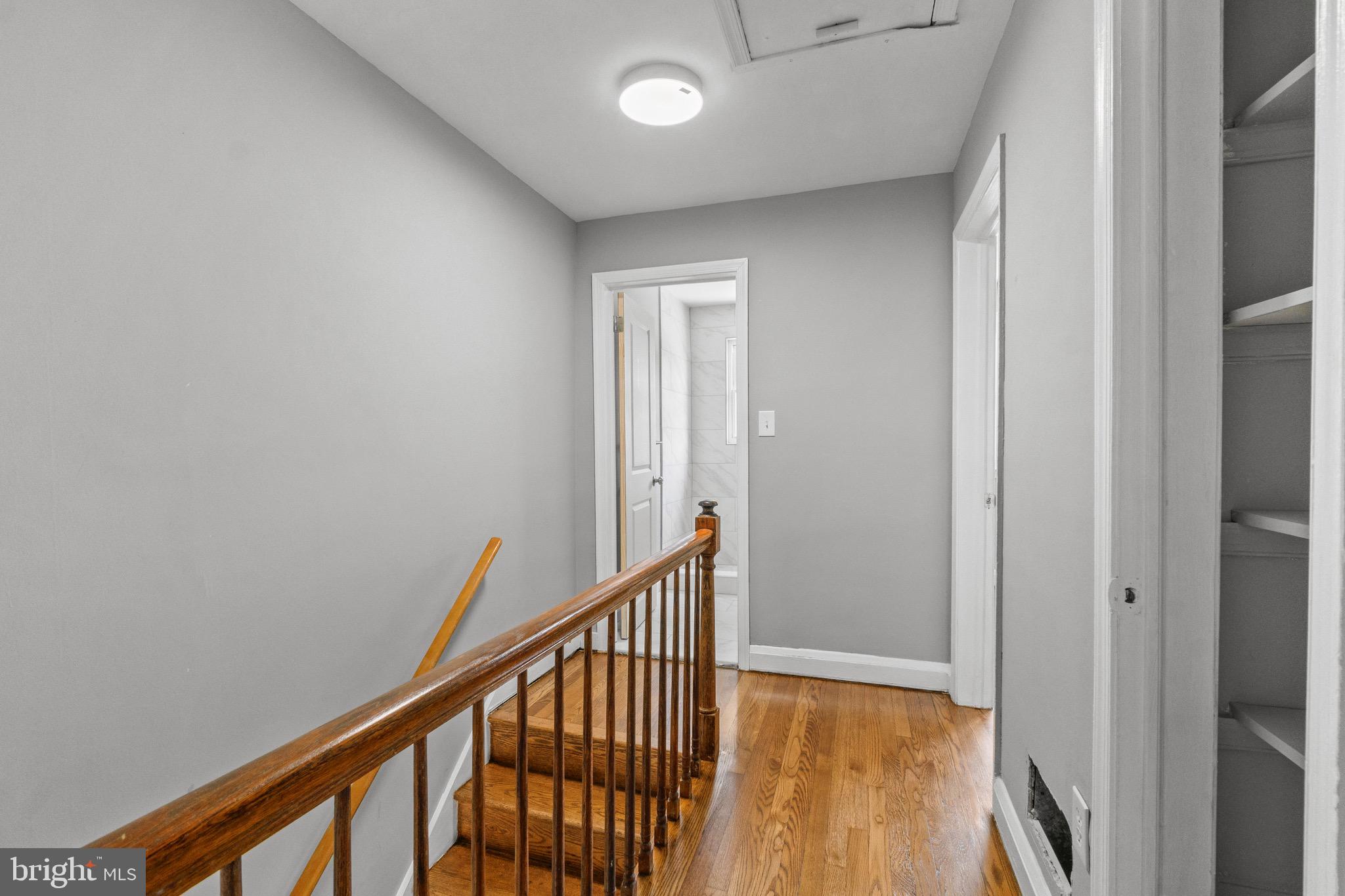 2214 Hawthorne Road Baltimore, MD 21220 - Photo 16 of 28 a view of a hallway with wooden floor and staircase
