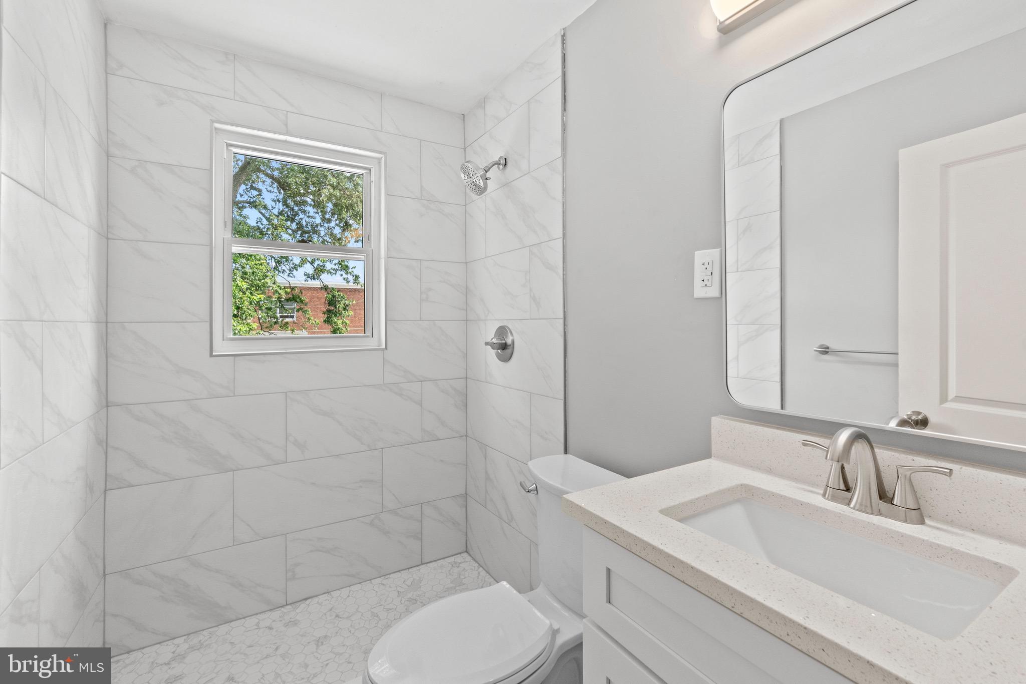 2214 Hawthorne Road Baltimore, MD 21220 - Photo 19 of 28 a bathroom with a toilet sink and mirror
