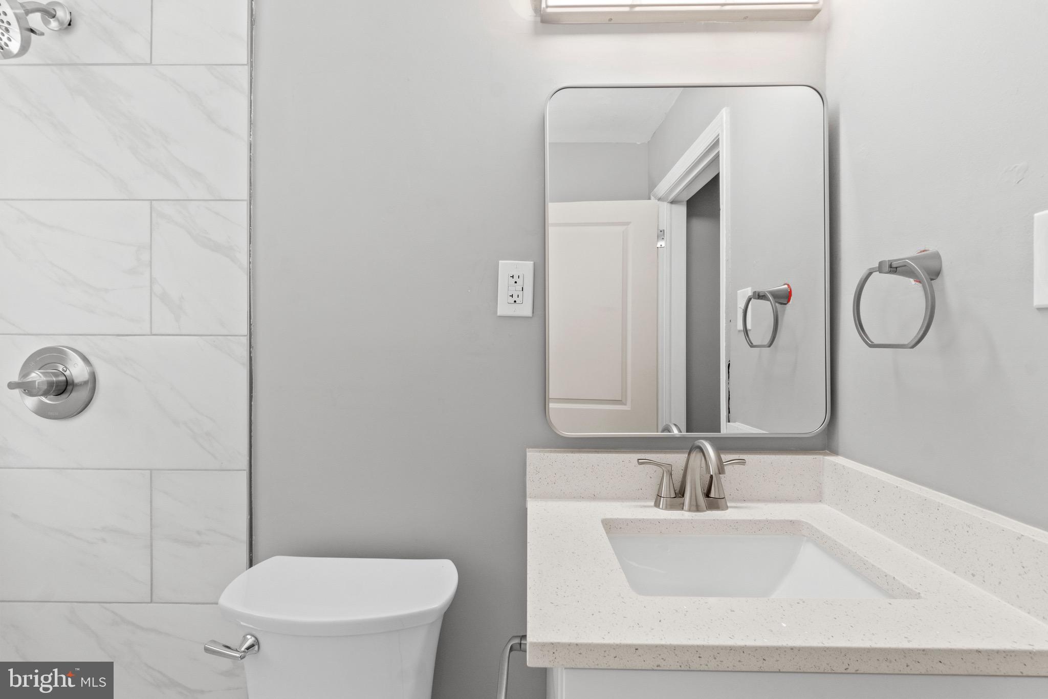 2214 Hawthorne Road Baltimore, MD 21220 - Photo 20 of 28 a bathroom with a sink a toilet and mirror
