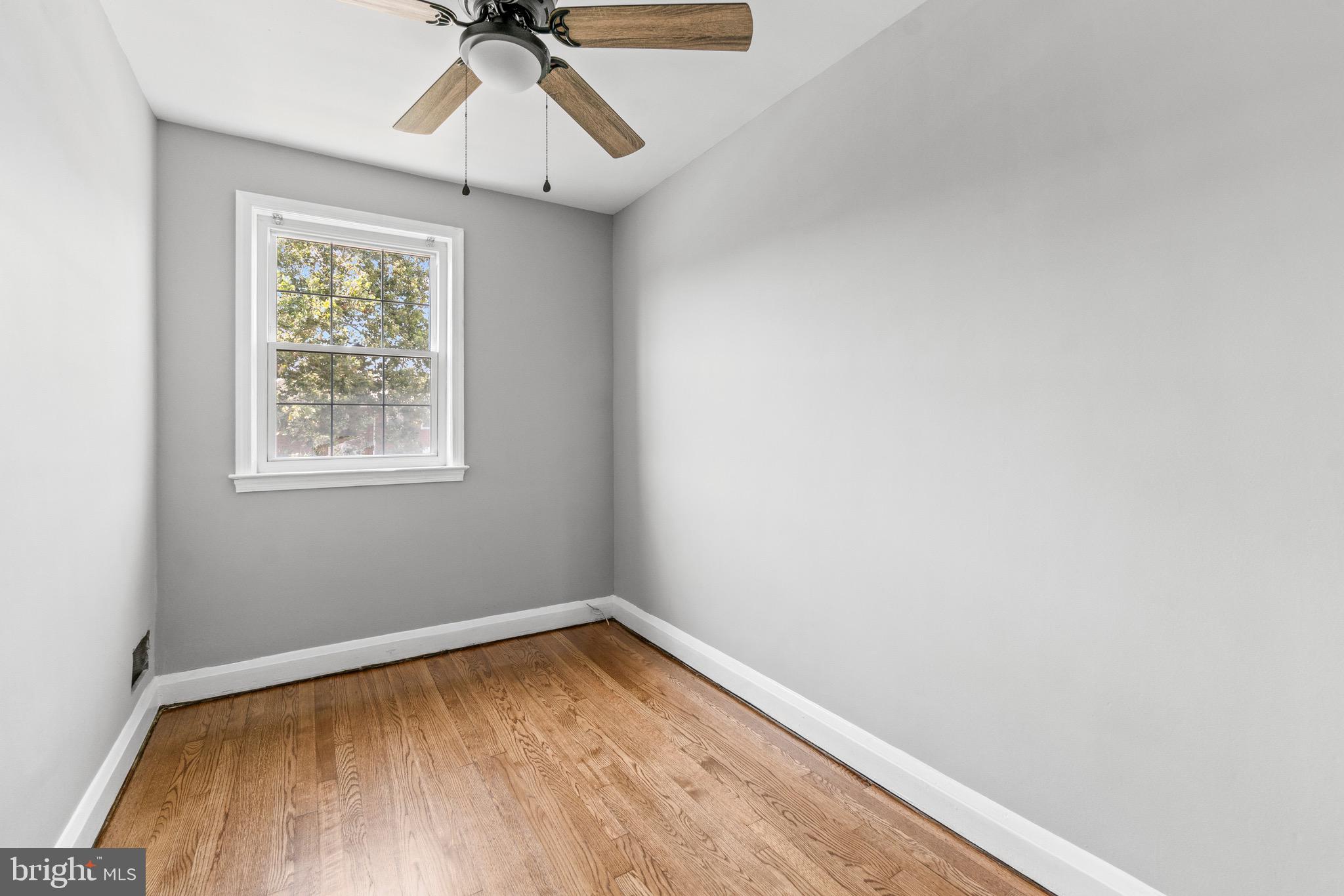 2214 Hawthorne Road Baltimore, MD 21220 - Photo 21 of 28 a view of empty room with wooden floor and fan