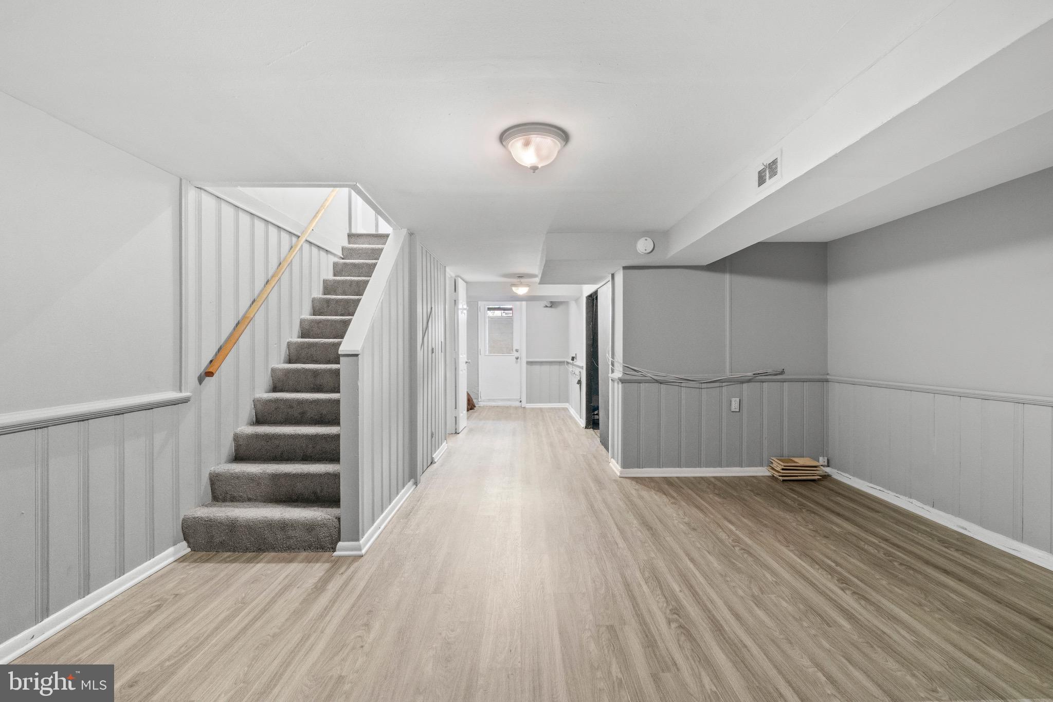 2214 Hawthorne Road Baltimore, MD 21220 - Photo 23 of 28 a view of a room with wooden floor and stairs
